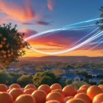 A golden hour view of a Riverside orange grove, with glowing blue and white light trails symbolizing the connectivity of Spectrum Internet Riverside CA to the homes in the background.