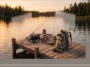 A 3D infographic render showing a rustic wooden dock with fishing gear and a camo bag, representing the outdoor lifestyle of the Catfish Girl.